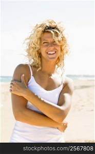 Portrait of pretty young blond woman smiling on Maui, Hawaii beach.