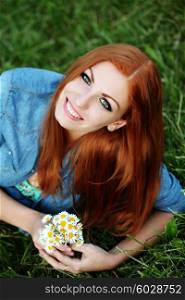 Portrait of pretty young female with daisy, outdoors, lifestyle, hair care