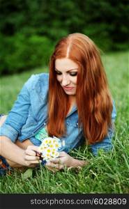 Portrait of pretty young female with daisy, outdoors, lifestyle, hair care