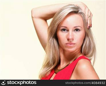 Portrait of pretty young woman in red dress against yellow background