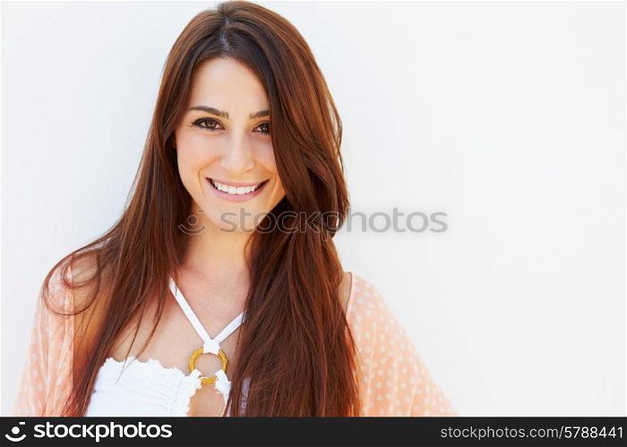 Portrait Of Pretty Young Woman Standing By Wall