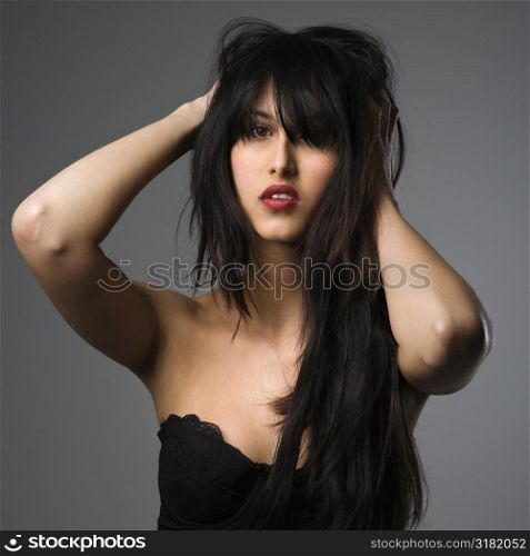 Portrait of pretty young woman with long black hair.