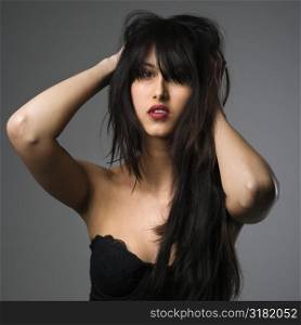 Portrait of pretty young woman with long black hair.