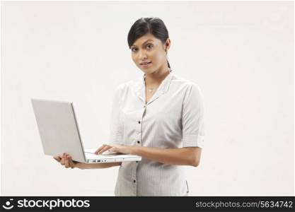 Portrait of pretty young woman working on laptop