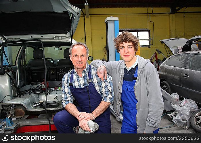 Portrait of professional and teenager in apprenticeship