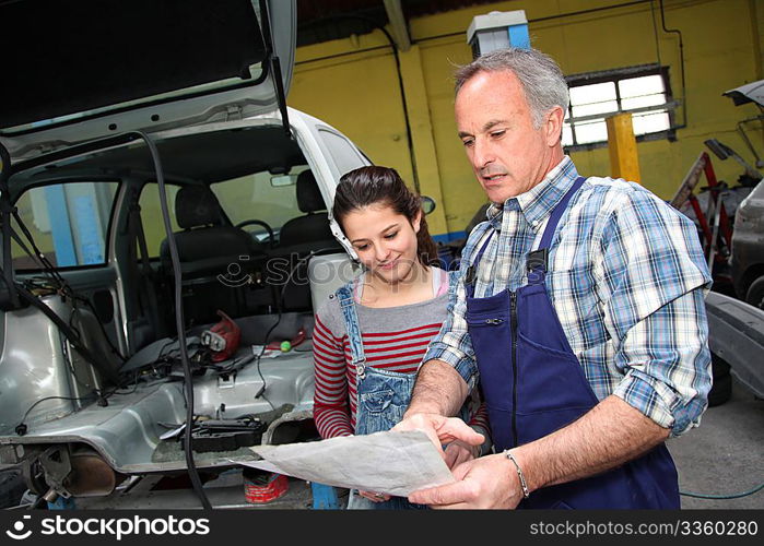 Portrait of professional and teenager in apprenticeship