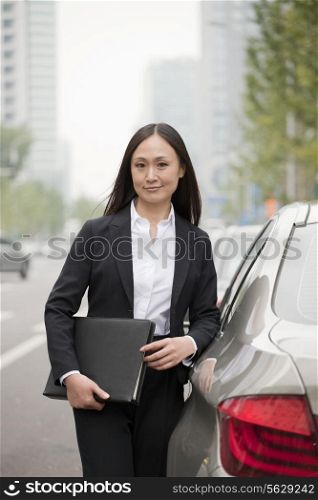 Portrait Of Professional Businesswoman Leaning On Car