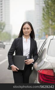 Portrait Of Professional Businesswoman Leaning On Car