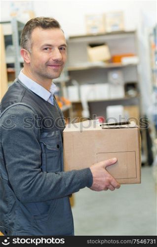 portrait of professional courier with boxes