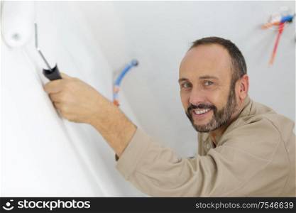 portrait of professional decorator using a paint roller