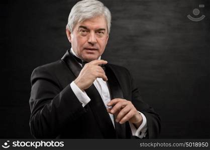 Portrait of professional hypnotist on black background
