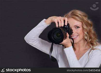Portrait of professional photographer holding photo camera