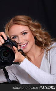 Portrait of professional photographer holding photo camera