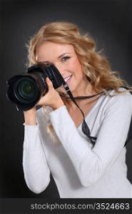 Portrait of professional photographer holding photo camera