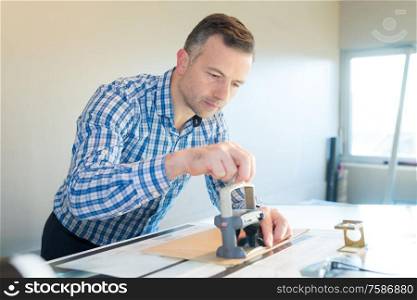 portrait of professional printer using stamp