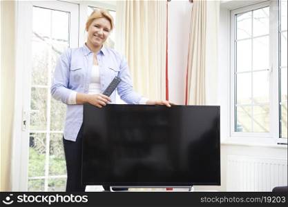 Portrait Of Proud Woman With New Television At Home