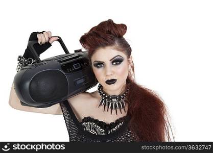 Portrait of punk woman holding boom box on shoulder over white background