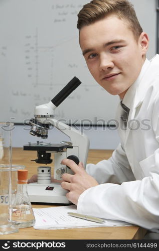 Portrait Of Pupil Using Microscope In Science Lesson