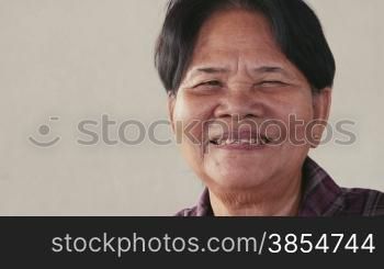 Portrait of real Asian people, with emotions and feelings, looking at camera. Happy old woman from Cambodia, Asia smiling. 12of62
