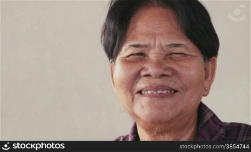 Portrait of real Asian people, with emotions and feelings, looking at camera. Happy old woman from Cambodia, Asia smiling. 12of62
