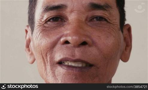 Portrait of real Asian people, with emotions and feelings, looking at camera, seniors. Serious old man from Cambodia, Asia. Closeup of face, 54of56