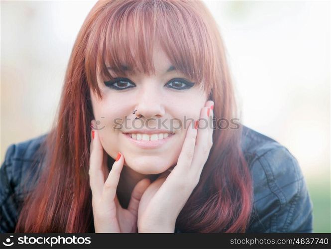 Portrait of rebellious teenager girl with red hair