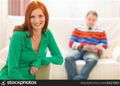 Portrait of red hair young woman and boyfriend in background