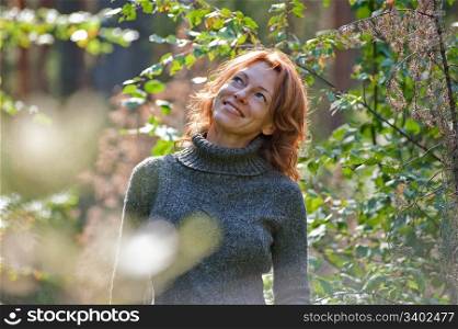 Portrait of red-haired adult women in nature