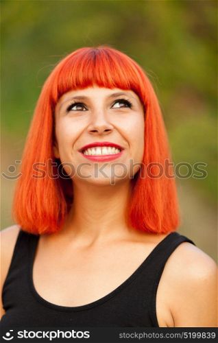Portrait of red haired woman enjoying of the nature