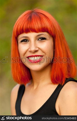 Portrait of red haired woman in a park