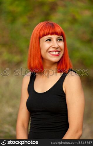 Portrait of red haired woman in a park