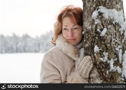 Portrait of red-haired woman in winters day.