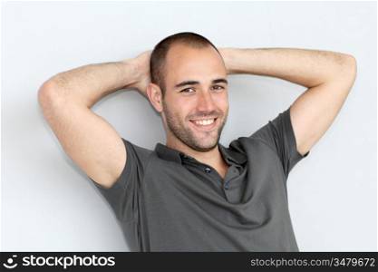 Portrait of relaxed man leaning on wall