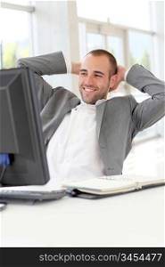Portrait of relaxed salesman in office
