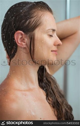 Portrait of relaxed woman with long hair in shower