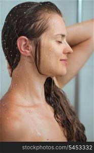 Portrait of relaxed woman with long hair in shower