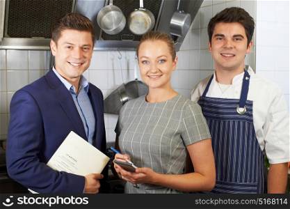 Portrait Of Restaurant Team Standing In Kitchen