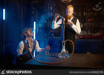 Portrait of retro guys smoking hookah pipe in bar. Business friends relax and spend time together. Portrait of retro guys smoking hookah pipe in bar