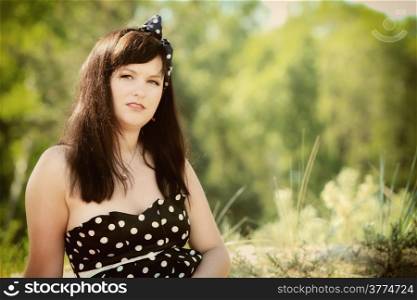 Portrait of retro woman pinup girl in the forest or park outdoor