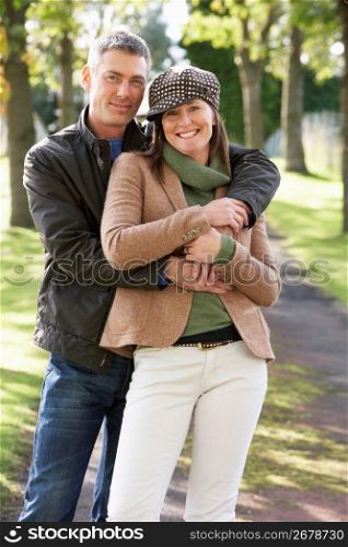 Portrait Of Romantic Couple Enjoying Outdoor Walk Through Autumn Park