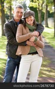 Portrait Of Romantic Couple Enjoying Outdoor Walk Through Autumn Park