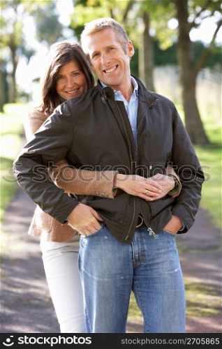 Portrait Of Romantic Couple Enjoying Outdoor Walk Through Autumn Park