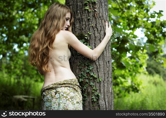 Portrait of romantic woman at the green forest