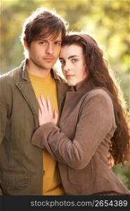 Portrait Of Romantic Young Couple In Autumn Landscape
