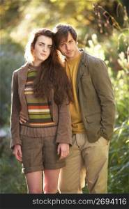 Portrait Of Romantic Young Couple In Autumn Landscape