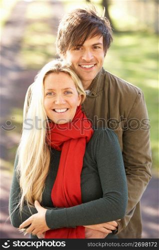 Portrait Of Romantic Young Couple In Autumn Park