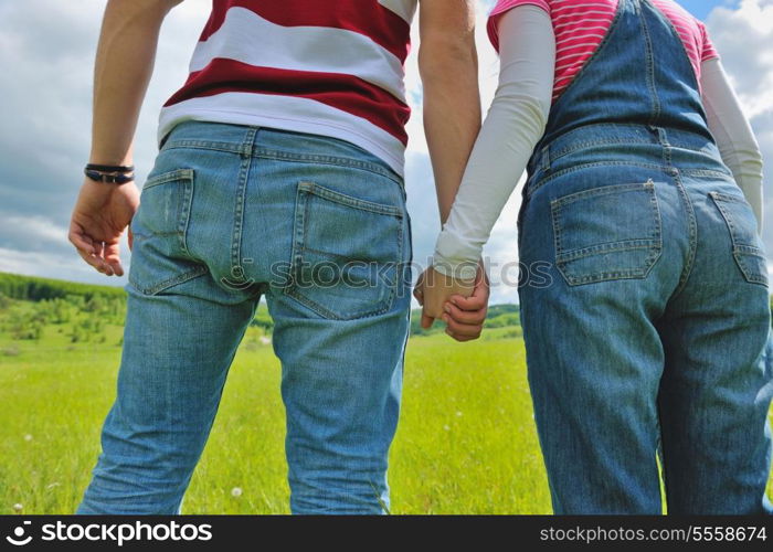 Portrait of romantic young couple in love smiling together outdoor in nature with blue sky in background