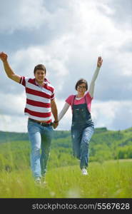 Portrait of romantic young couple in love smiling together outdoor in nature with blue sky in background