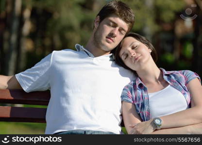 Portrait of romantic young couple in love smiling together outdoor in nature with blue sky in background