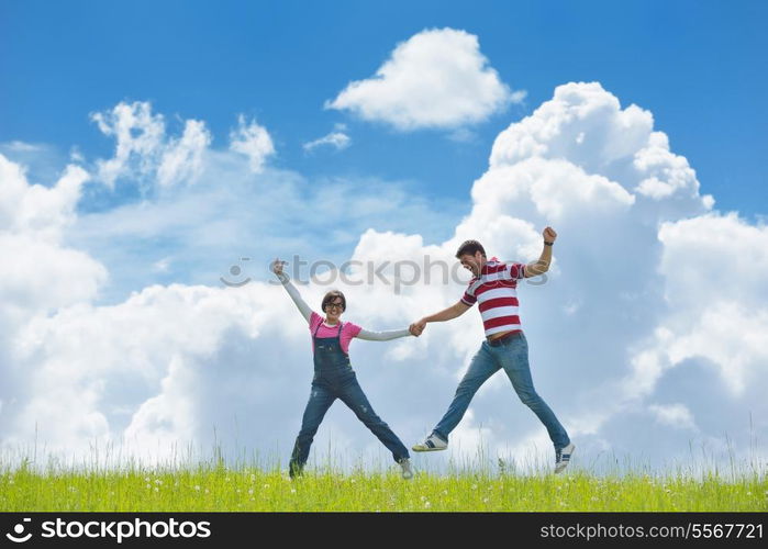 Portrait of romantic young couple in love smiling together outdoor in nature with blue sky in background